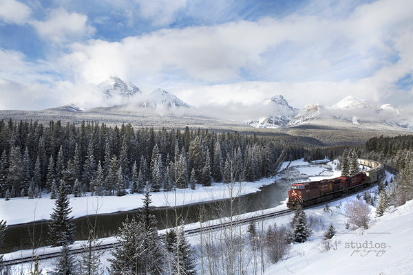 Winter wonderland image of a Canadian Pacific train roaring through rugged Canadian Rockies. Banff National Park. Alberta photography. Home decor by J2 Studios.