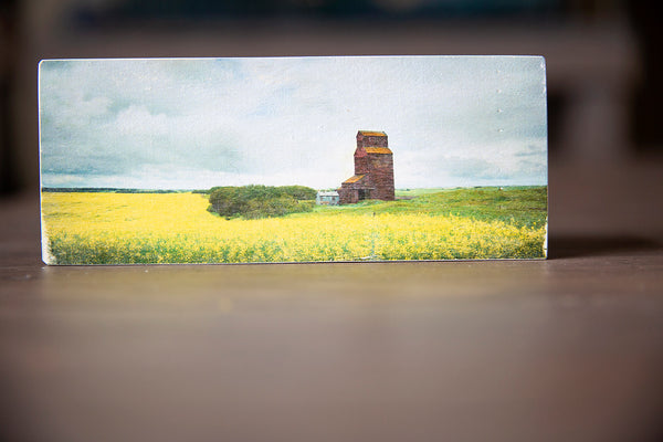 Wood magnet of a canola field with a grain elevator in Canada. Handmade in Edmonton by Larry Jang, artist & photographer. Fridge decor. Prairie Love.