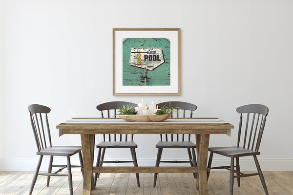 Framed Alberta Wheat Pool print on display in rustic dining room.