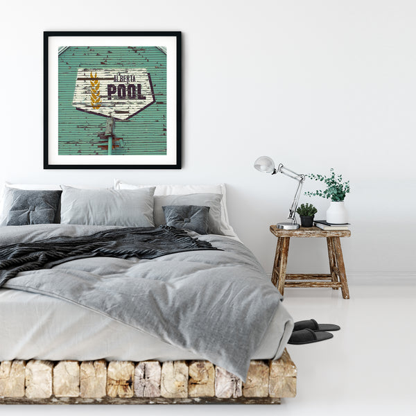 Framed print of chic and iconic Alberta Wheat Pool logo in rustic modern bedroom.