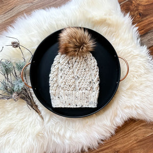 Speckled beige knit toque with faux fur pom pom