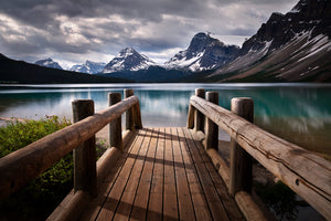 Photo of mountains, a bridge and a lake
