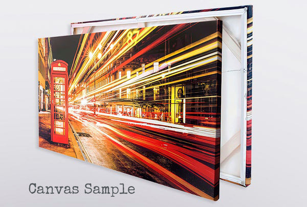 Museum-grade canvas print featuring a long-exposure London street scene with a red telephone box and vibrant light trails.