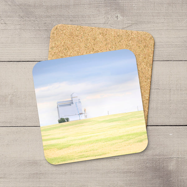 Square coaster with a glossy grain elevator prairie landscape print, rounded corners, and a protective cork backing.