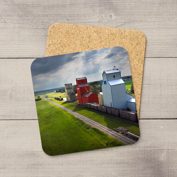 Square 3.75-inch coaster with a glossy Prairie grain elevator photo, rounded corners, and a non-slip cork backing.