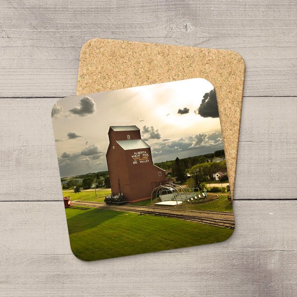 Square coaster with a glossy Alberta Wheat Pool grain elevator print, rounded corners, and a protective cork backing.