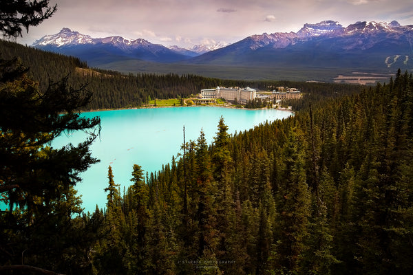 Artwork of Fairmont Chateau and the turquoise waters of Lake Louise with snow capped mountains of Banff National Park. Serene mountain decor.