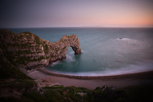 Image of the natural limestone sea arch on the Jurassic coast of Dorset, England. Landscape photography.