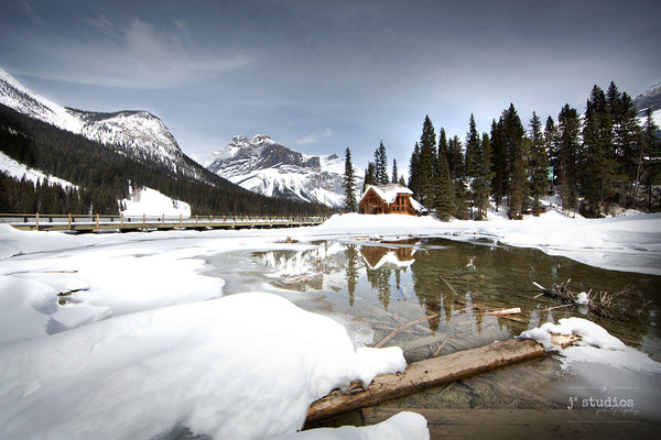 Image of Emerald Lake Lodge reflecting off the frozen romantic waters of Emerald Lake.  British Columbia Rockies photography.