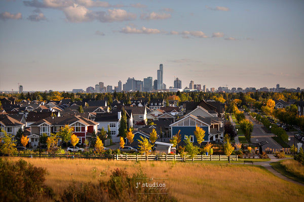 Image of Edmonton Skyline from Griesbach Hill in Autumn. This picture has a San Francisco vibe featuring colorful houses against metropolitan skyline.  Postcard image of YEG by Larry Jang.