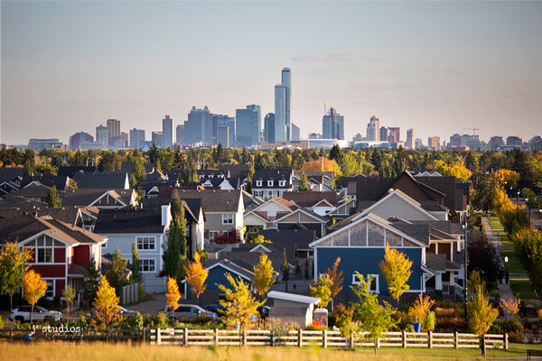 Edmonton Skyline looming over colorful houses of Griesbach neighbourhood. Fall postcard photography.
