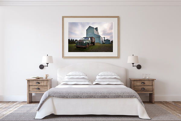 Framed print of a jalopy in front of a grain elevator. Fine art photography by Larry Jang.