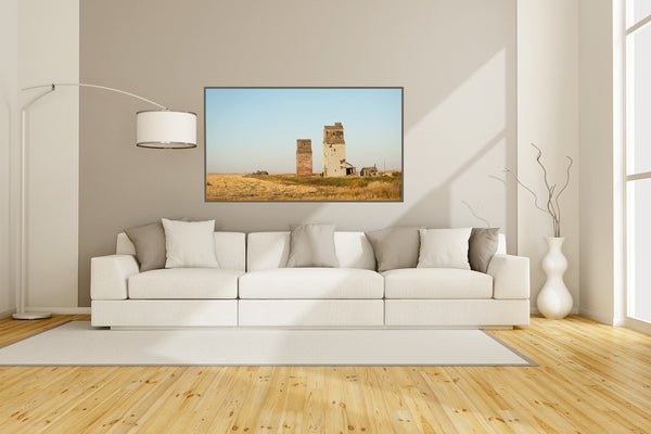 Framed canvas print of grain elevators in Dankin Saskatchewan hanging in a modern living room.