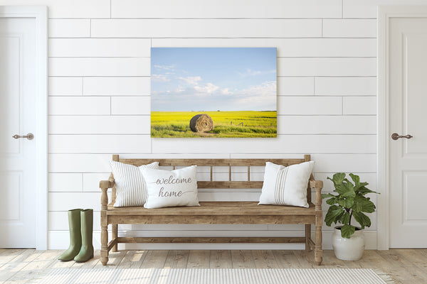 Farmhouse decor. Big canvas print of bale of hay on canola field.