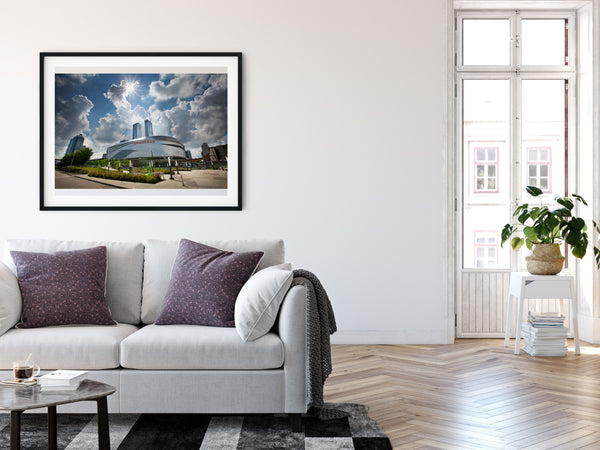 Framed Print of Rogers Place in Edmonton on the living room wall of an urban apartment. 