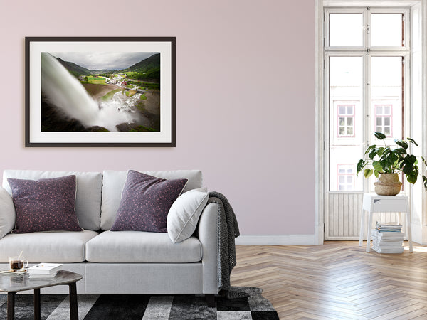 Framed waterfall print hanging on urban walls of modern metropolitan home.