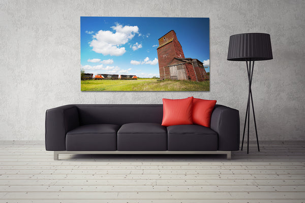 Big canvas of CN train passing Alberta grain elevator on display in modern living room.