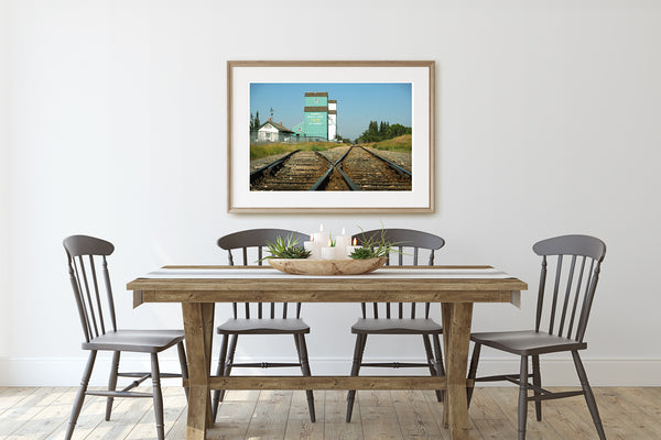 Wooden framed print of St Albert Grain Elevators in rustic dining room.