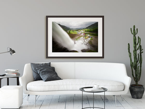 Framed waterfall print hanging in a modern living room. Condo decor ideas.