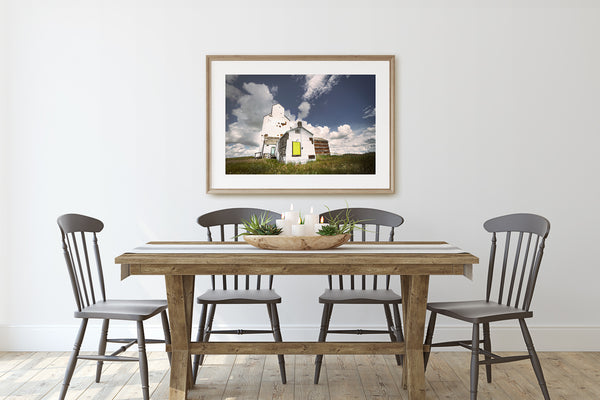 Print of Grain elevator in wooden frame on display in Rustic Modern Dining Room.