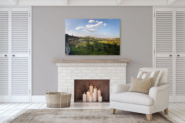 Print of Edmonton River Valley on display in a cozy living room with  a fireplace.