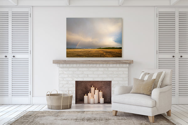 Canvas print over fireplace mantle featuring a double rainbow on the Alberta Prairies. Fine Art Photography by Larry Jang.