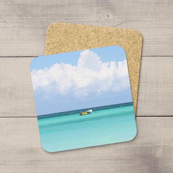 Photo Coasters of a boat drifting on Caribbean Sea in Jamaica. Souvenirs & home accessories. Handmade in Edmonton, Alberta by Canadian photographer & artist Larry Jang.