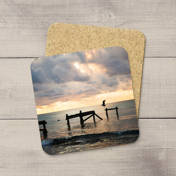 Photo coasters of a pelican landing on a pier in Playa Del Carmen Mexico. Souvenirs & travel themed home accessories. Handmade in Edmonton, Alberta by Canadian photographer & artist Larry Jang.