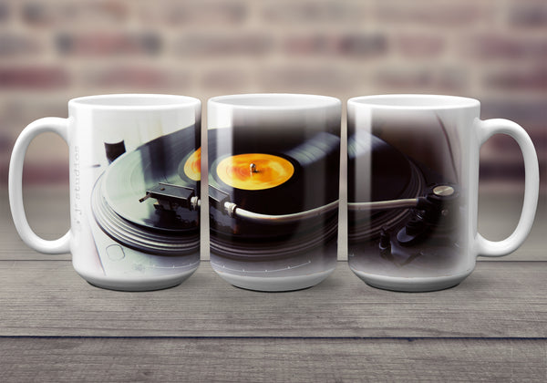 Urban themed 15 oz Coffee Mug for music lovers. It features a wrap image of a turntable playing a record in a cafe. Handmade in Edmonton, Canada by photographer & artist Larry Jang.
