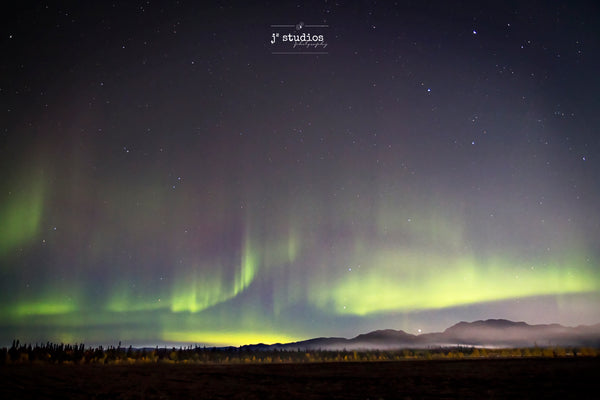 Aurora Through the Fog is an art print of the northern lights over the Yukon Territory.