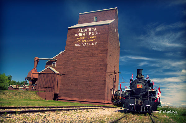 Picture of the Engine 41 Steam Locomotive parked on the railroad tracks outside of Big Valley Grain Elevator. Alberta Prairies photography by Larry Jang