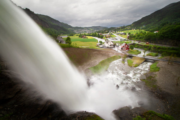 Beautiful picture of water flowing from Steinsdalfossen into the green valley below. Colorful houses in Norway are also featured here. Stunning Landscape Photography by Larry Jang