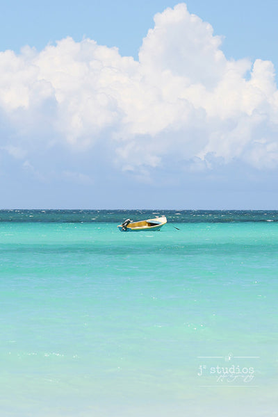 Adrift is an art print of a boat floating on the Caribbean Sea in Jamaica.