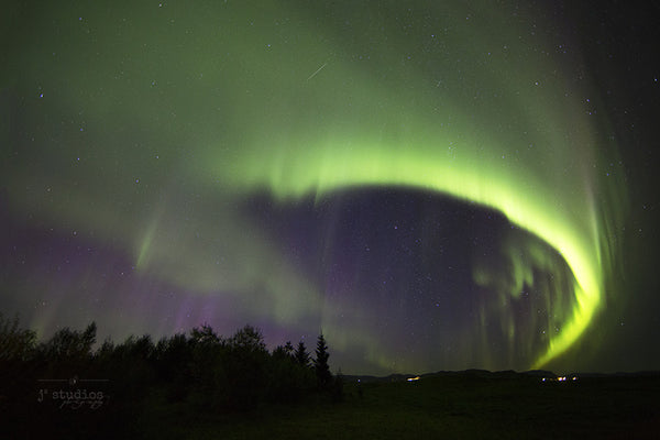 Arcing Over Iceland is an art print of the northern lights dancing in the heavens above Iceland. Fine Art photography.