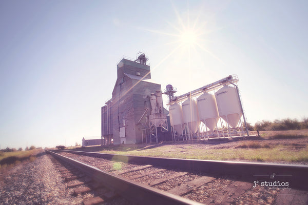 Wanderlust themed picture of Strome Grain Elevator photographed by the train tracks. Alberta photography by Larry Jang.