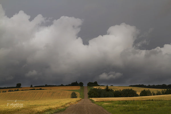 Picture of a country road leading straight into a turbulent prairie summer storm. Alberta Photography. by Larry Jang.