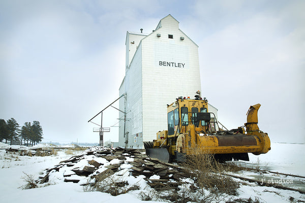 Image of a Railroad Snow Plow parked in front of the Bentley Grain Elevator in Alberta. Art Prints of Alberta.