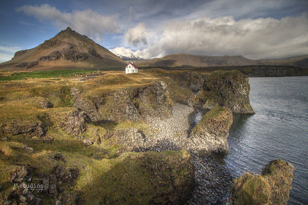 Home By the Sea is an image of a charming oceanfront home nestled along the cliffs of Arnarstapi Village in West Iceland.