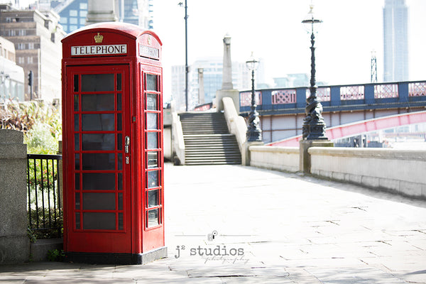 Fine art prtint of a red telephone booth along the waterfront of London, England. Landmark photography.