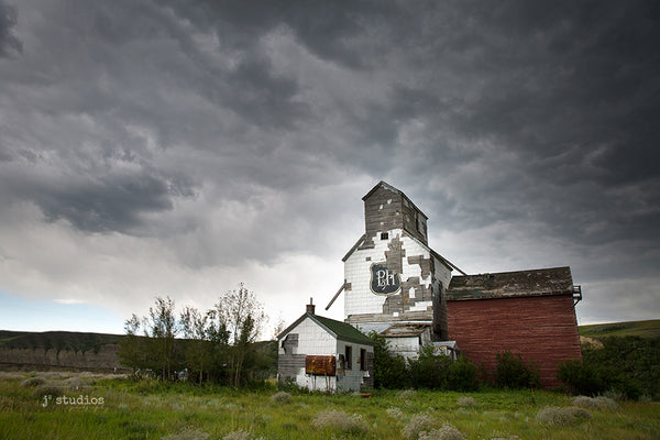 Dramatic image of the badlands in Sharples featuring the weathered P&H grain elevator moments before a massive summer storm hit!