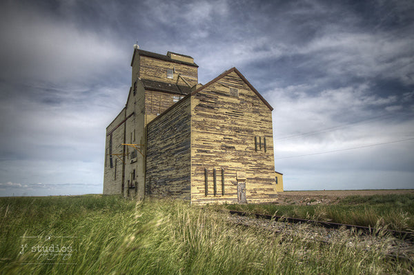 Old Memory on the Prairie is an art print of the grain elevator in Skiff, Alberta. Heritage themed railroad photography.