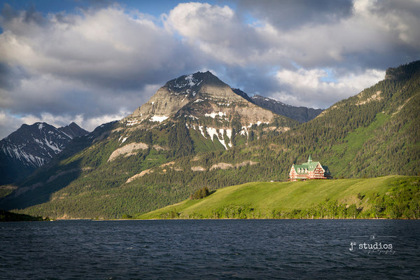 Image of the Prince of Wales Hotel standing peacefully along the shores of Upper Waterton Lakes in Waterton National Park in Alberta, Canada.  Iconic historical hotel in the pristine Canadian Rockies. Alberta Photography.