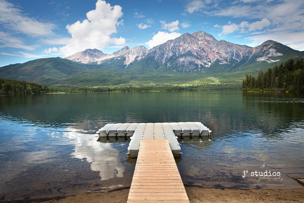 Art print of a pier bridging the shores of Jasper National Park and Pyramid Lake. Best images of Alberta.