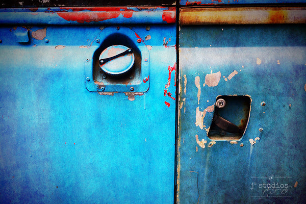 Shades of Blue is a photograph print of the gas cap and handle of an electric blue Land Rover in Norway. 
