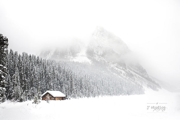 Snowy Day in Louise is a winter wonderland themed image of a Log Cabin and Mount Fairview in Banff National Park. Winter Landscape. Rocky Mountain Photography.