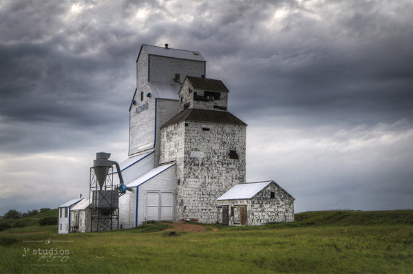 Still Standing in Altario is an art print of the grain elevator in Eastern Alberta. Storm Cloud Photography with heritage themes.