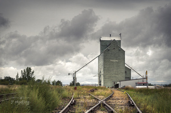 Trochu Junction is an art print of the railway crossroad and grain elevator in this Central Alberta town. Heritage themed photography.