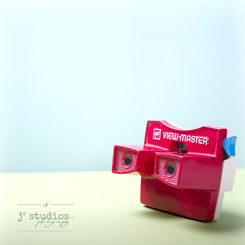 Viewmaster is an art print of the red 1970s stereoscopic toy. 